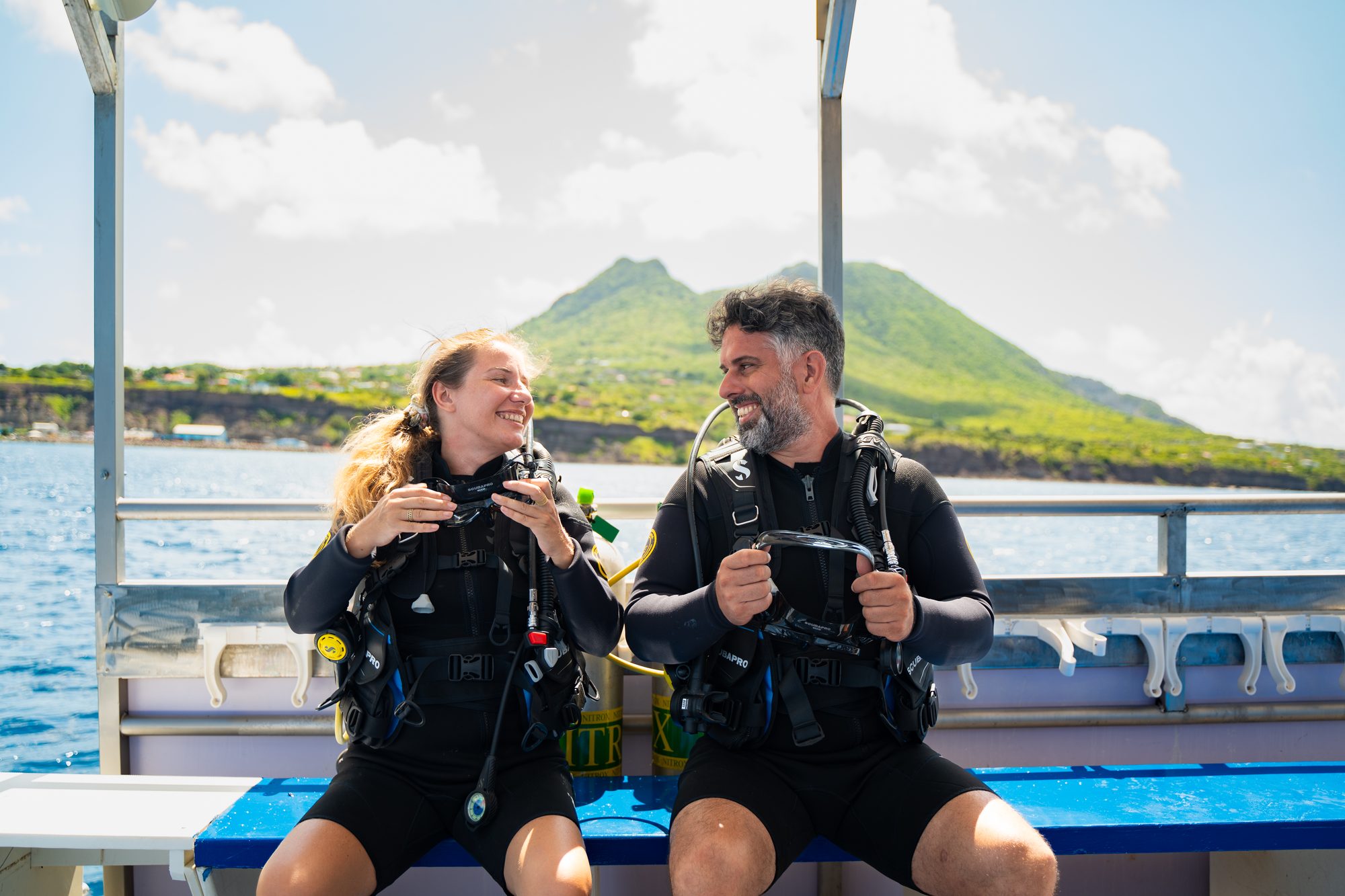 On the dive boat off Oranjestad, with the Quill behind